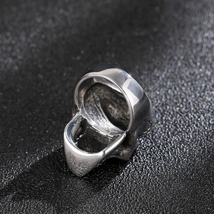 Macro shot of polished stainless steel biker skull ring with smooth inner surface finish