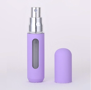 Close-up of a 5ml purple refillable perfume spray bottle with silver nozzle and clear window