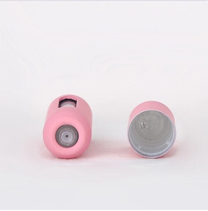 Detailed view of pink refillable perfume atomizer with viewing window and spray nozzle