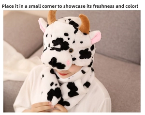 Detailed plush cow hat with integrated scarf and mittens featuring cute horns and ears