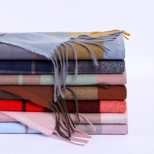 Detailed stack of multi-color plaid scarves with soft cashmere feel and fringe edges