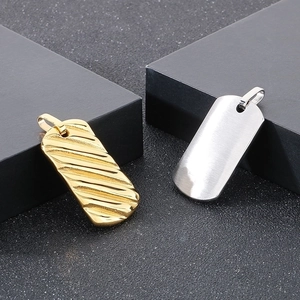 Detail of 18k gold plated bar pendants showing wave texture and brushed metal finish