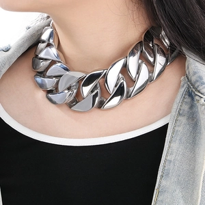 Close-up of chunky 43mm silver stainless steel Cuban link chain necklace on model