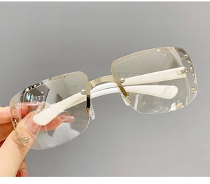 Macro detail of Y2K rimless shield sunglasses with silver studs and white temples