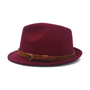 Detail of burgundy fedora wool hat with brown suede belt and gold metallic buckle