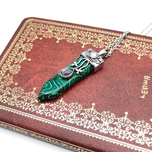Detailed view of malachite pendulum necklace with vintage silver metalwork and stones