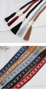 Detailed view of woven tassel charms and floral lace ribbons in various colors