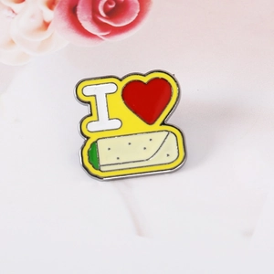 Close-up of yellow enamel lapel pin with I love Burrito text and taco illustration
