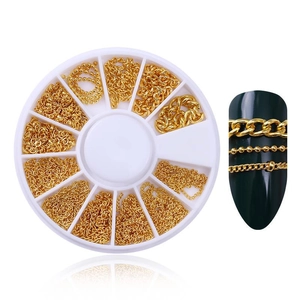 Macro detail of golden nail art chains with a storage box and decorated nail tips