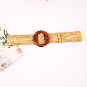 Wide straw woven belt for women featuring a large dark brown circular wooden buckle