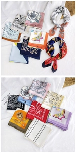 Detail view of assorted patterned silk square scarves with paisley and floral prints