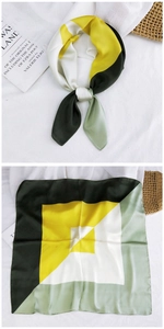Detail of satin square scarf featuring geometric color blocking in yellow and green