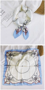 Detail of blue and cream square silk scarf with vintage rope and badge patterns