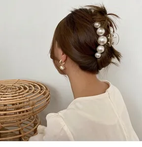 Elegant Korean style large pearl hair claw and matching earrings shown on female model