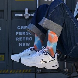 Street style view of orange and blue tie-dye crew socks paired with white sneakers