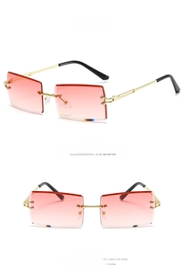 Detail of pink gradient rectangular rimless sunglasses with gold metal temples