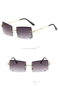 Detail view of rimless square sunglasses with gold metal temples and gradient grey lenses