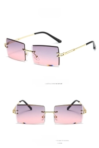 Detail of gold rectangular sunglasses with rimless gradient lenses and metal temples
