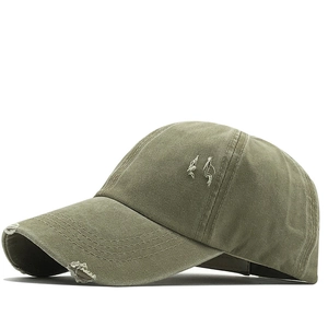 Detailed close-up of army green washed cotton baseball cap featuring vintage distressed holes