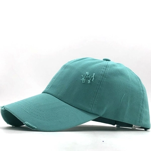 Detailed side view of distressed washed cotton ponytail baseball cap in cyan blue finish