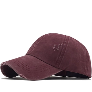 Macro detail of washed cotton baseball cap showing vintage distressed edge and texture