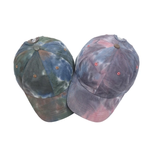 Detail of colorful tie-dye ponytail baseball caps showing rear hole and 6-panel structure