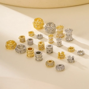 Macro detail of gold and silver plated animal charms with inlaid zircon for DIY jewelry