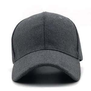 Detailed macro view of dark grey wool blend baseball cap showing thick felt texture