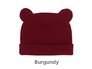 Macro detail of the soft wine red knitted cotton baby beanie with cute bear ears
