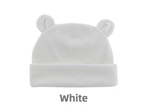 Close-up of white knitted baby hat with cute bear ears and a folded brim detail
