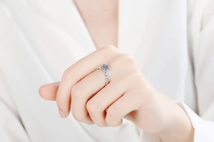 Classic S925 sterling silver six-prong moissanite ring worn on a woman's finger