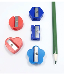 Flat lay of colorful plastic pencil sharpeners in circle, hexagon, and heart shapes