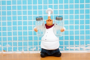 Detail of resin chef spice rack holder with two clear glass seasoning bottles