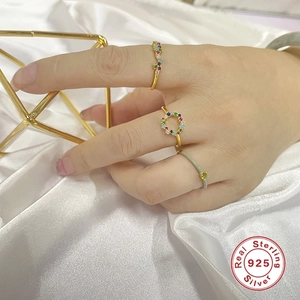 S925 sterling silver gold ring set with colorful stones on white silk background