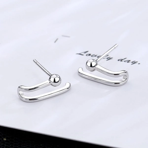 Minimalist silver paperclip earrings with a polished mirror finish on a clean white background