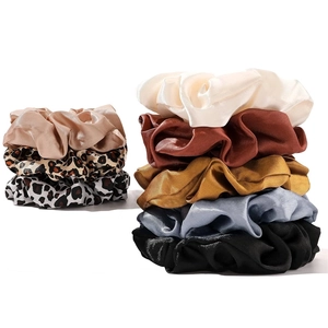 Satin fabric scrunchies set in solid colors and leopard prints on a white background