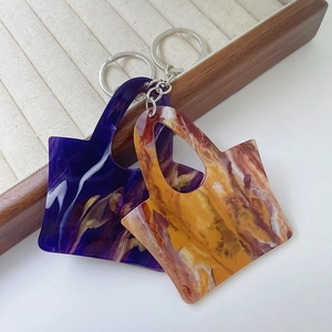 Creative marble texture acrylic handbag keychains in purple and orange with gold accents