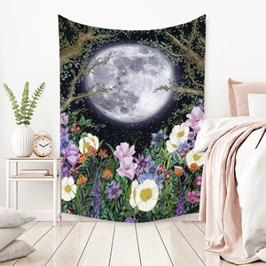 Detail of bohemian tapestry featuring a large moon over a dark forest and colorful flowers