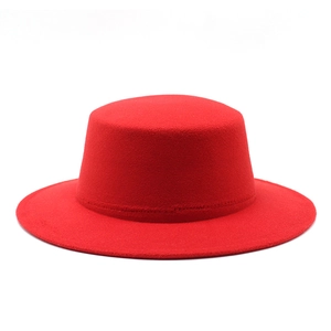 Detailed view of the flat top red wool felt hat with a wide brim and precise stitching