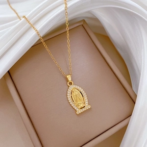 Gold oval Virgin Mary necklace with crystal halo on white silk and beige jewelry box