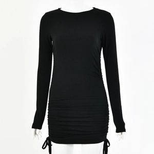 Detail view of black ribbed knit mini dress featuring side drawstring and ruched texture