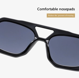 Detail shot of sunglasses with comfortable nose pads and sleek black frame design