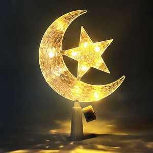 Detail view of transparent moon and star LED light with warm yellow glow and battery box