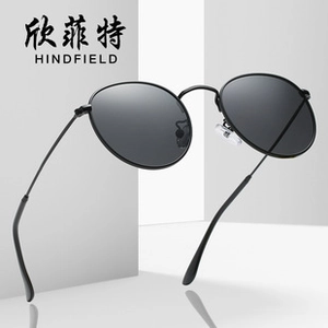 Close-up of retro slim metal frame with deep gray lenses on oversized sunglasses