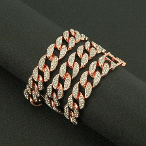 Macro detail of rose gold Cuban link bracelet encrusted with sparkling rhinestones