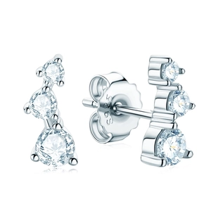 Macro shot of 925 silver stud earrings with three sparkling Moissanite stones in a curve