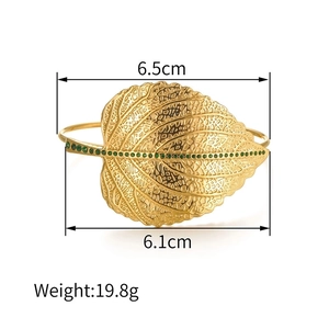 Golden leaf cuff bracelet with green gemstones and detailed vein texture, 6.5cm width