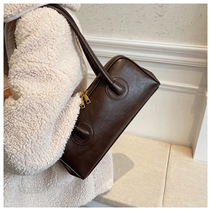 Detailed macro of dark brown PU leather shoulder bag with smooth texture and gold zipper