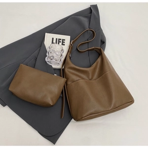 Brown faux leather bucket bag set with matching pouch and grey blazer styling