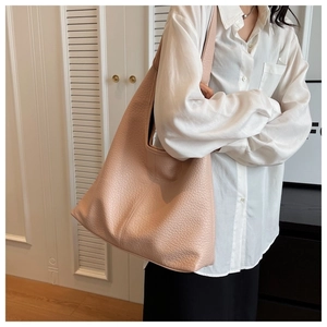 Detail of soft pink lychee grain leather tote bag showing large capacity and texture